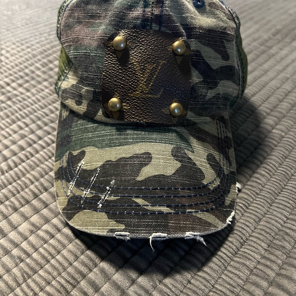 Camo trucker hat with Louis Vuitton patch.